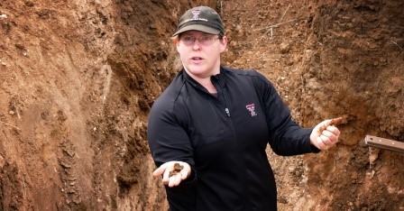 SHI Technical Specialist Dr. Lindsey Slaughter holds soil while describing soil texture in soil pit